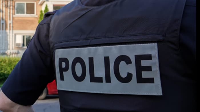 Un policier devant une maison.
