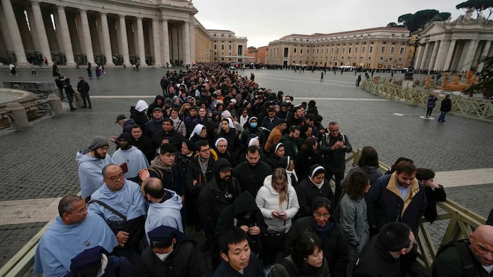 People wait in a line to enter St. Peter's Basilica Monday.