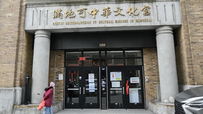 A man walks toward the building that houses the Chinese Family Services office of Greater Montreal on Saturday, March 9, 2024.