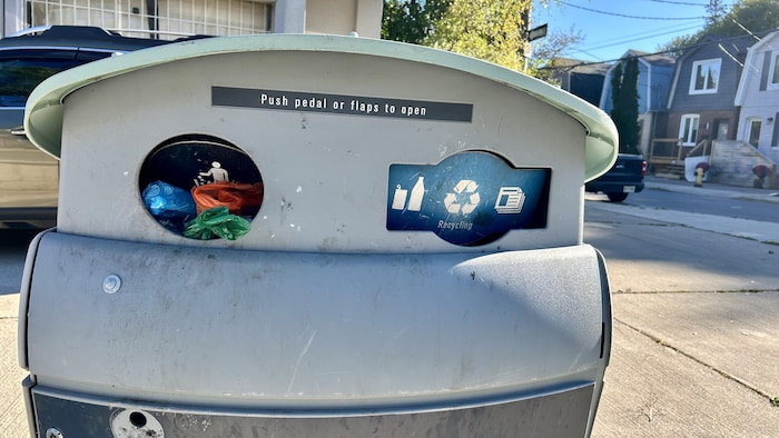 Une poubelle dont l'ouverture pour les déchets est petite.