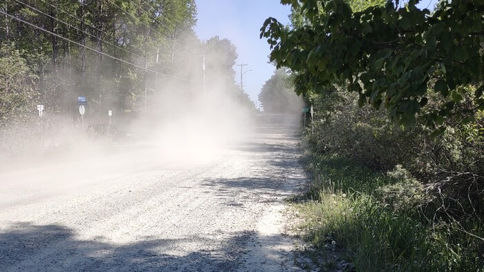 Un chemin de terre avec de la poussière.