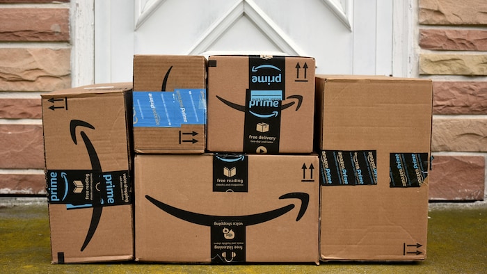 Des boîtes de carton d'Amazon devant une porte.