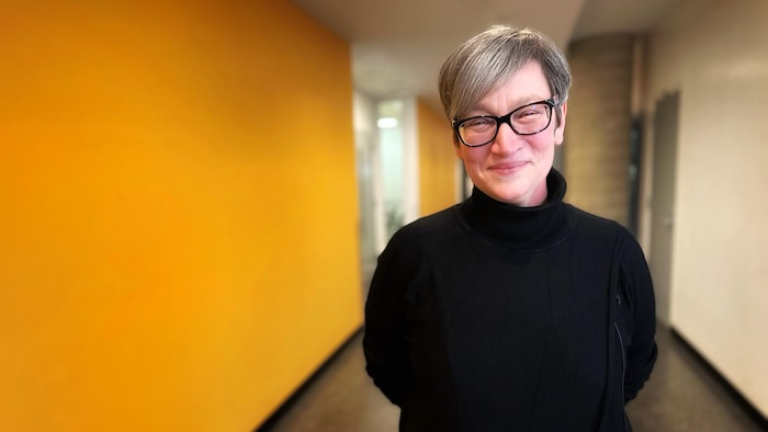 A didactics teacher at the University of Quebec in Montreal smiles for the camera