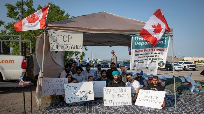 Singh is joined in his protest in the parking lot by about 15 other international students.