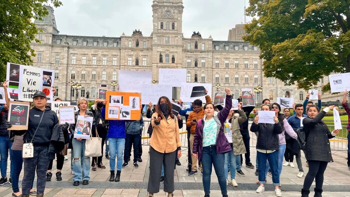 Iranians in Quebec City gathered outside Quebec's National Assembly Sept. 21 to show support to those in Iran protesting the death of Mahsa Amini. (Rachel Watts/CBC)