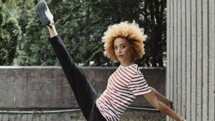 Una bailarina levanta una de sus piernas al cielo