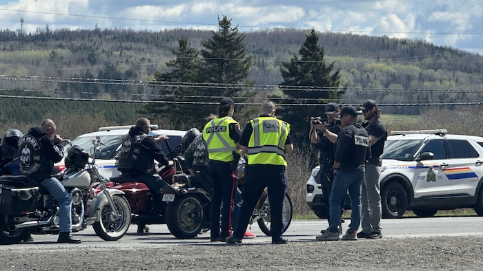 Des policiers prennent des motards en photo.