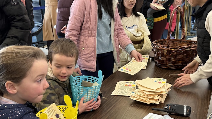 Children present their findings and their clue sheets at the validation table.