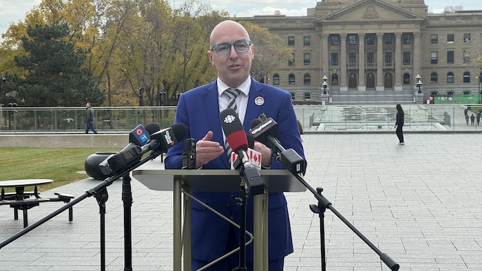 Andrew Knack devant un lutrin devant l'Assemblée législative de l'Alberta à Edmonton.