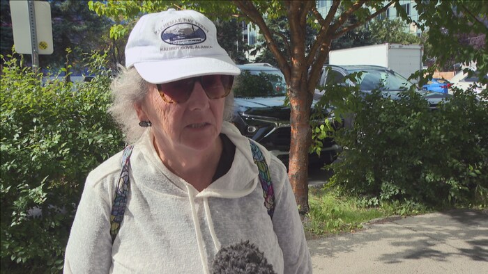 Elle répond aux questions dans un micro.