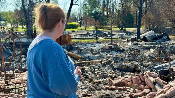 Rhonda Werbicki in front of rubble.
