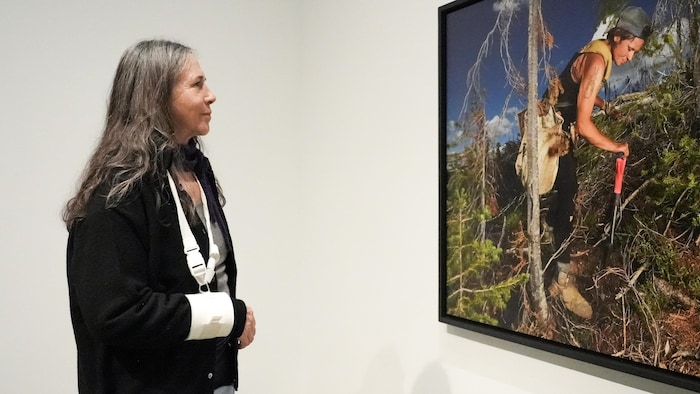 Rita Leistner regarde une photographie en grand format à la galerie d’art de Kelowna, le 23 janvier 2026.