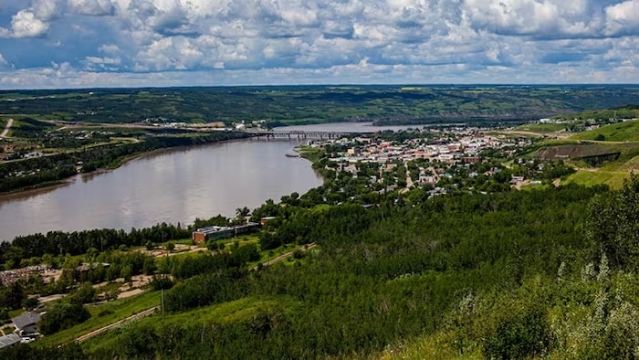 A body of water surrounded by green in Alberta.