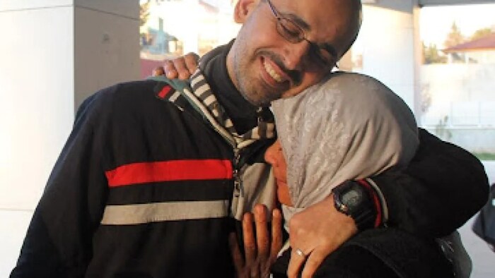 Former Syrian political prisoner Riyad Avlar hugs his mother after spending 21 years in prison in Syria.