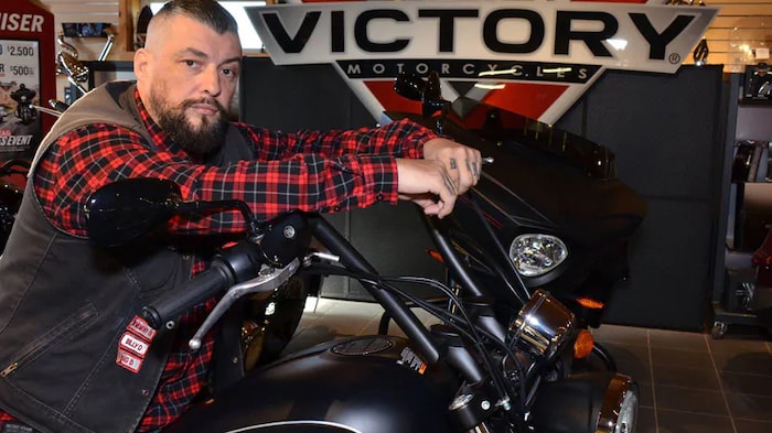 Robin Moulton with a caliphon on a motorcycle.