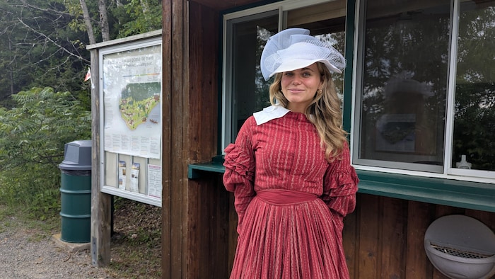 The host poses in period clothes.