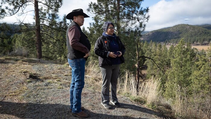 Shackan Indian Band Chief Arnie Lampreau, left, and Assembly of First Nations National Chief RoseAnne Archibald talk as they stop to view damage caused by last summer's wildfires and November flooding west of Merritt, B.C., on March 24.