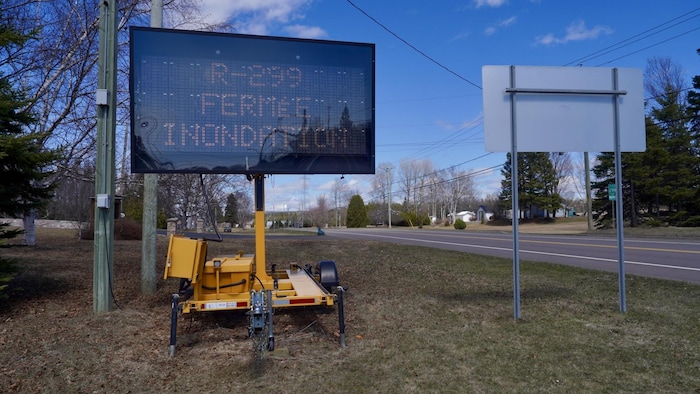 Un panneau indicateur signale aux automobilistes que la route 299 est fermée à la suite d'une inondation.
