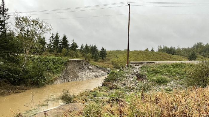 A road cut in half.  accabling report coroner after drama
