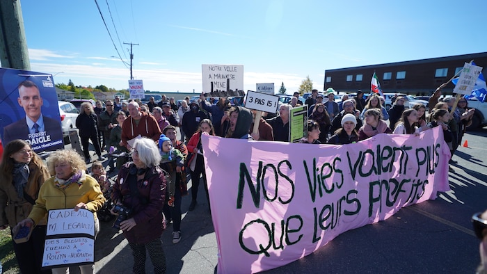 Des personnes rassemblées avec des affiches.