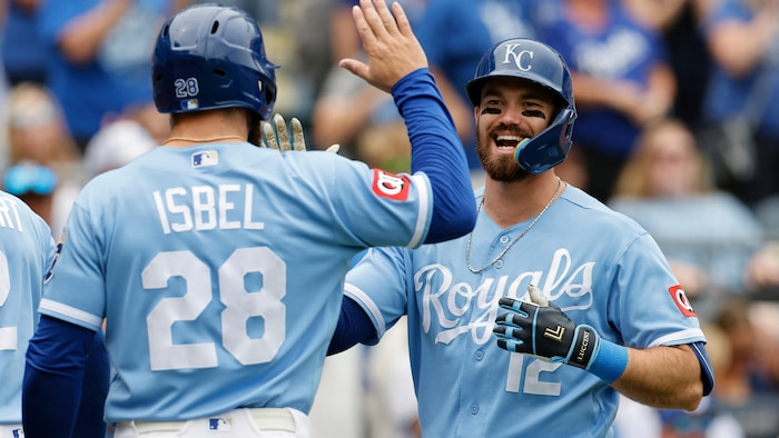 Deux joueurs des Royals célébrent un coup de circuit en se donnant la main.