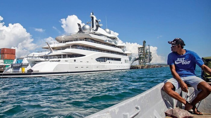 Boat captain Emosi Dawai looks at the superyacht Amadea where it is docked.