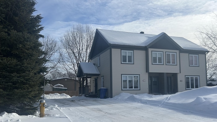Une maison jumelée vue de l'extérieur en hiver.
