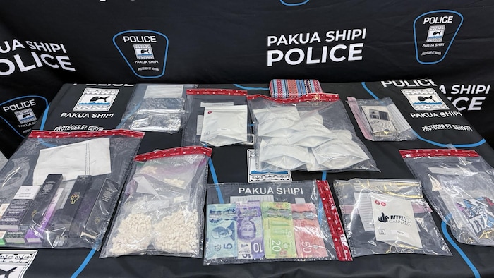 De la drogue et des dollars canadiens présentés sur une table au poste de police de Pakua Shipi. 