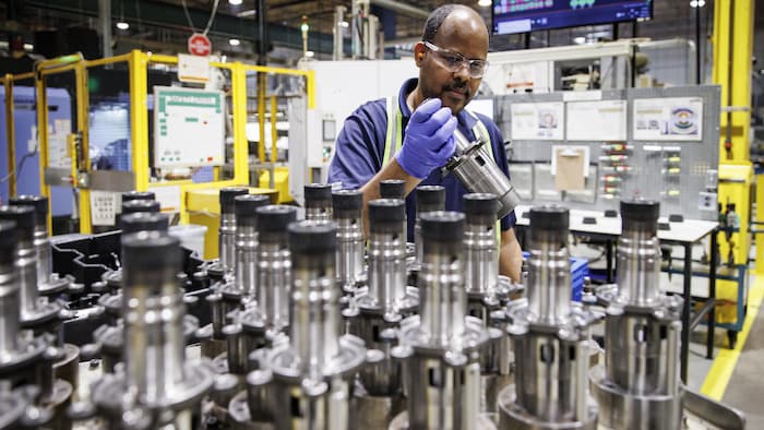 Un salarié d'une usine travaille sur une production.