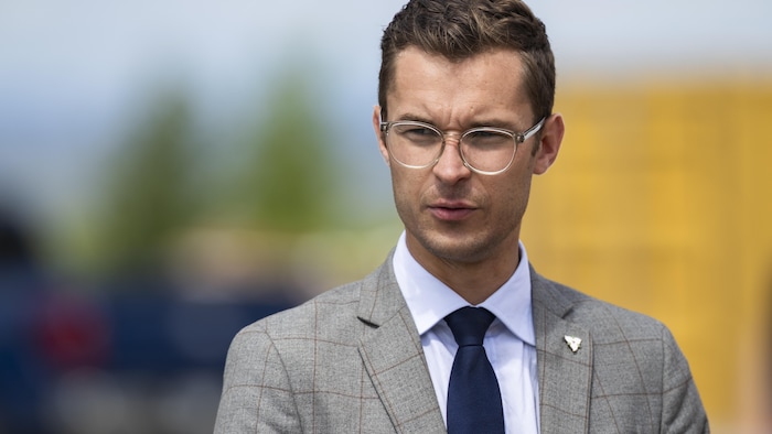 Le député provincial conservateur de l'Ontario Sam Oosterhoff écoute une allocution du premier ministre ontarien Doug Ford lors d'un projet de développement résidentiel à Hamilton, le lundi 24 août 2026.