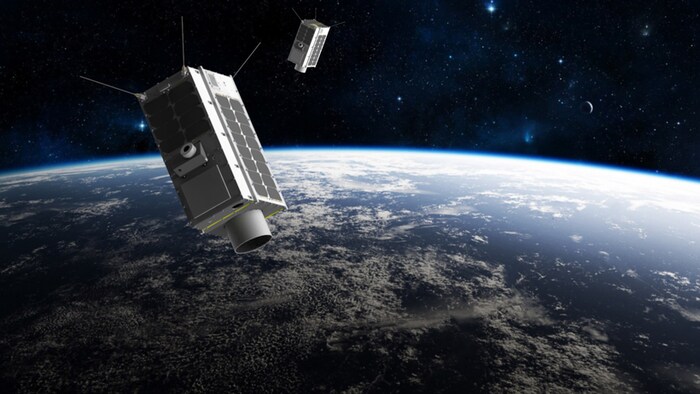 Impression artistique de deux satellites en orbite autour de la Terre.