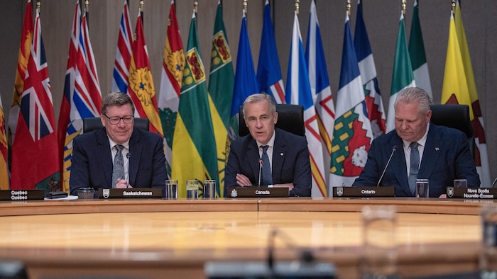 Le premier ministre de la Saskatchewan, Scott Moe, le premier ministre du Canada, Mark Carney, et le premier ministre de l'Ontario, Doug Ford, lors d'une rencontre avec les premiers ministres canadiens à Saskatoon, le 2 juin 2025.