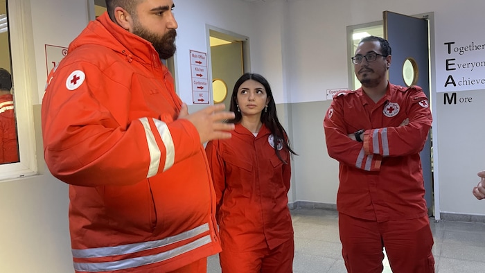 Rescuers returning from a mission after an Israeli strike in Beirut's southern suburb.