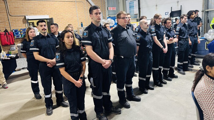Des ambulanciers debout dans une salle.