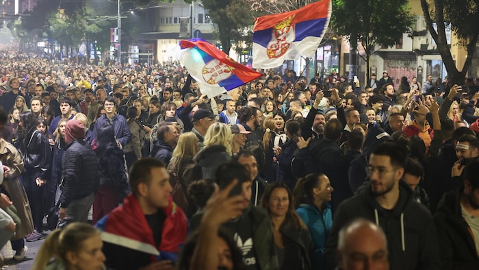 Des gens célèbrent dans les rues de Belgrade.