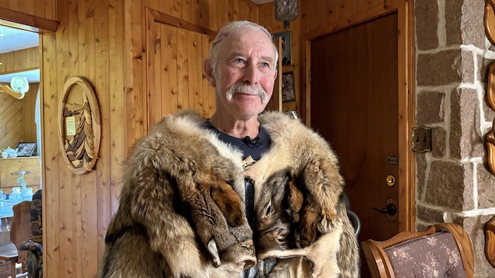 Serge Guitard vêtu d'un manteau en peaux de coyotes.