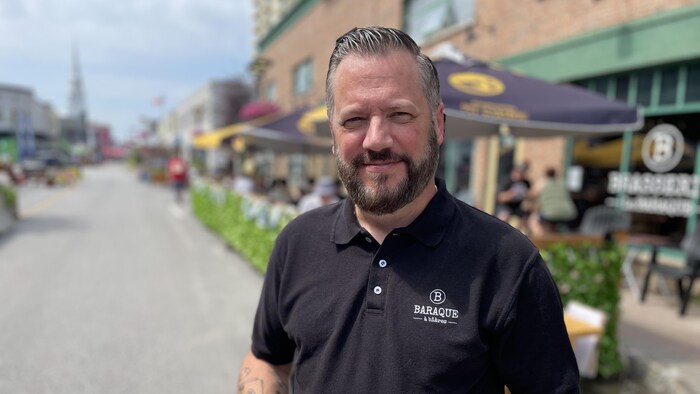 Simon St-Pierre devant la terrasse de son restaurant en été.