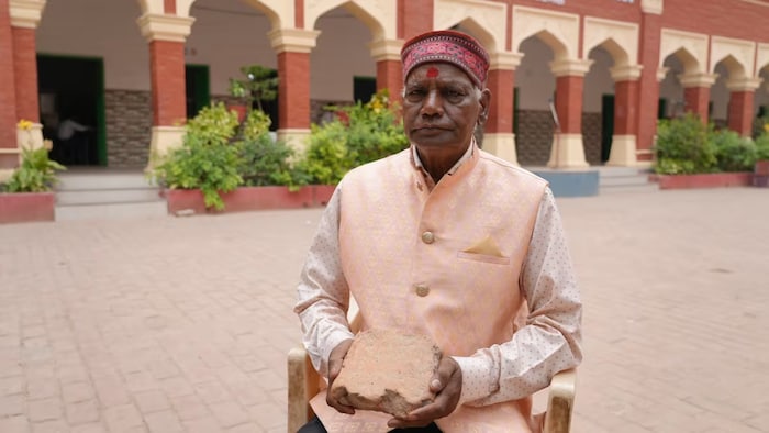 Sohan Lal Arya holds the brick he kept as a memento from the day the Babri mosque in Ayodhya was torn down by a Hindu nationalist mob. 