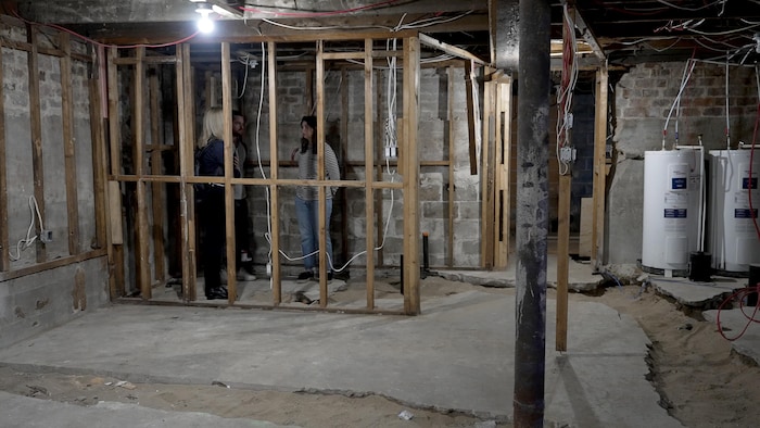 Noémie Platard and Raoul Davin in the basement of their destroyed house.