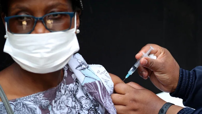 A health-care worker administers the Johnson & Johnson COVID-19 vaccine to a woman in Johannesburg on Aug. 20. Scientists in that country first detected a new C.1.2 variant there in May.