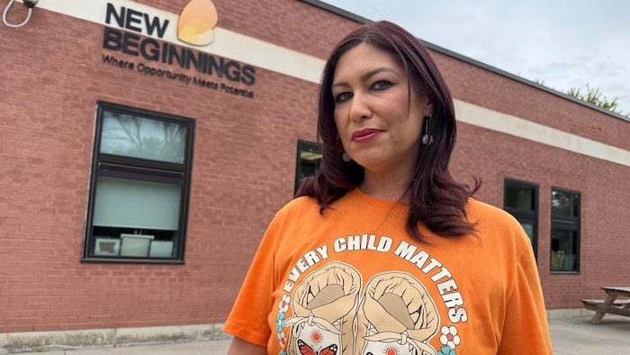 Portrait de Stacey Yannacopoulos avec un chandail orange "every child matters".