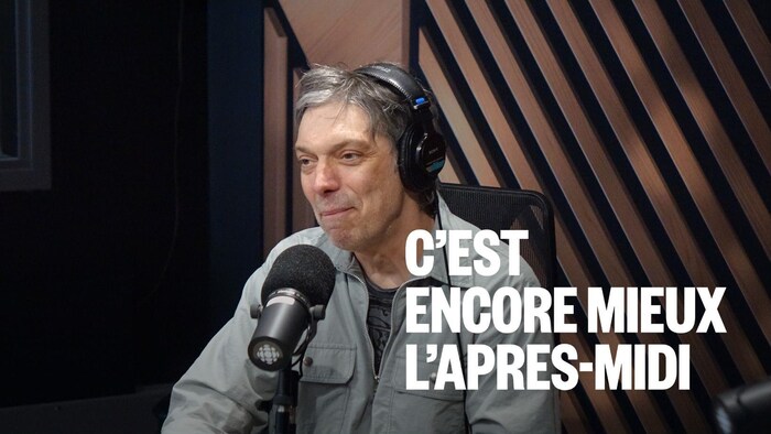 Un homme assis dans un studio radio.