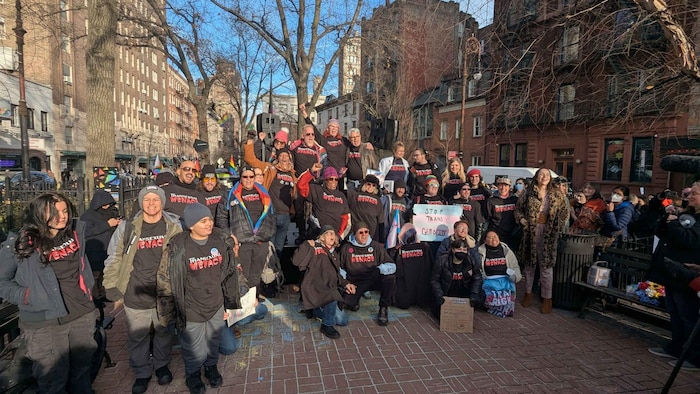 La photo montre un groupe de manifestants qui portent des t-shirts sur lesquels on peut lire : The Transexual Menace.
