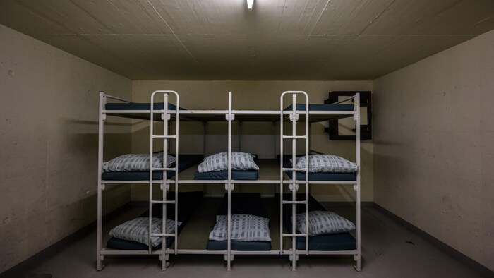 Beds ready to be used inside a bunker dormitory