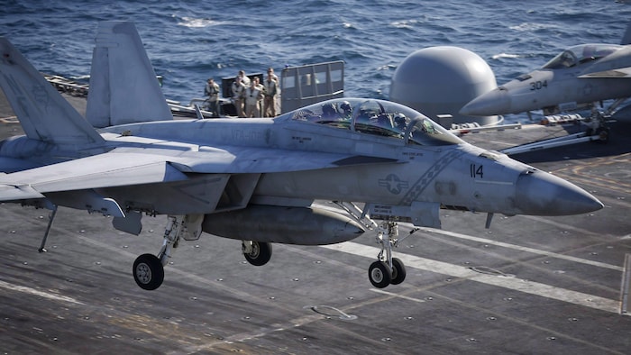 A Boeing Super Hornet lands on a US aircraft carrier during a joint US-South Korea military exercise in October 2015.
