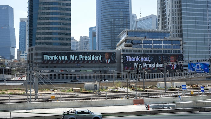Signs display a message thanking US President Donald Trump.