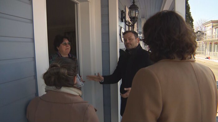 Paul St-Pierre Plamondon parle à une électrice sur le perron d'une maison.