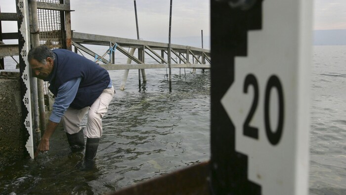 Un employé des autorités israéliennes mesure le niveau d'eau du lac de Tibériade.
