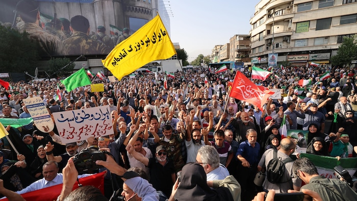 Iranians brandish flags and signs during a demonstration. weakened iranian regime, but not