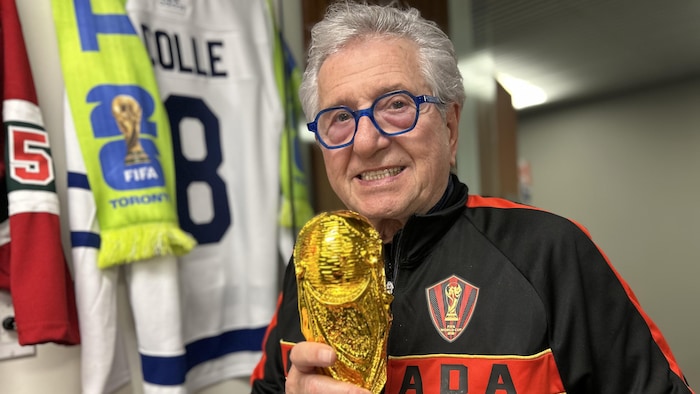 Le maire adjoint de Toronto Mike Colle tenant une réplique de trophée de la Coupe du monde de soccer.